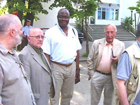 Don Prenz, holding pipe, with fellow poets; Kama Kamanda, to his right. Photo: M. Hibert.