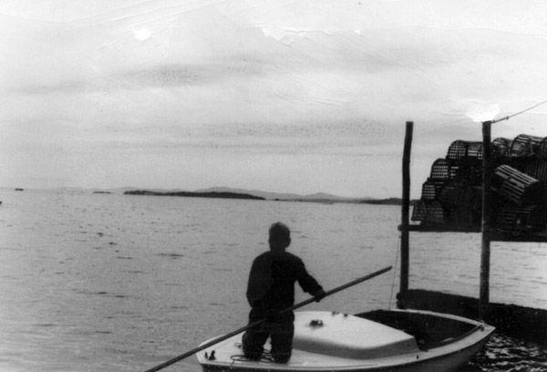 George Oppen kneeling on their boat. 1968.